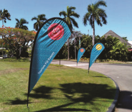 Colorful tear drop sail flags set up at an outdoor event, showcasing brand logos and capturing attention.